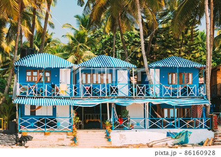 Canacona, Goa, India. Famous Painted Guest Houses On Beach Against Background Of Tall Palm Trees In Sunny Day 86160928