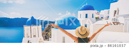 Happy summer fun woman enjoying sun on Europe holiday, Greece travel destination, Oia Santorini banner panorama. Tourist at the three blue domes 86161037