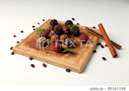 Concept of sweets with chocolate candies on white background Concept of sweets with chocolate candies on white background 86161398