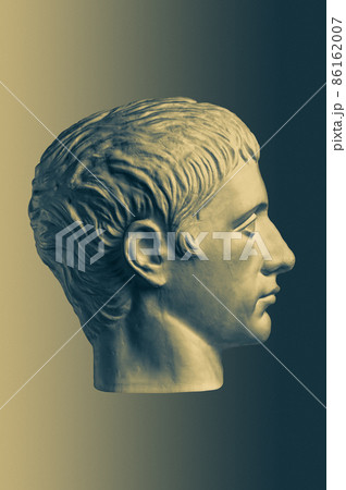 Bronze color gypsum copy of ancient statue of Germanicus Julius Caesar head for artists on brass background. Renaissance epoch. Plaster sculpture of man face. Template for art design Bronze color gypsum copy of ancient statue of Germanicus Julius Caesar head for artists on brass background. Renaissance epoch. Plaster sculpture of man face. Template for art design 86162007