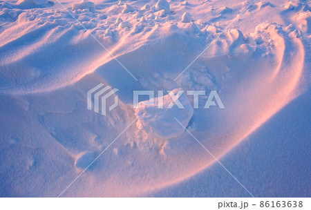Snowdrift waves in sunset light, purple evening light at winter with a lot of snow, horizontal landscape image Snowdrift waves in sunset light, purple evening light at winter with a lot of snow, horizontal landscape image 86163638