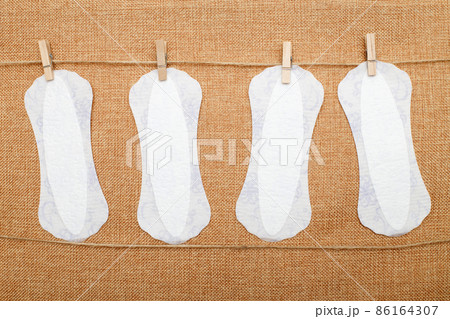 panty liners hanging on clothespins on a textile background. hygiene and women's health care concept 86164307