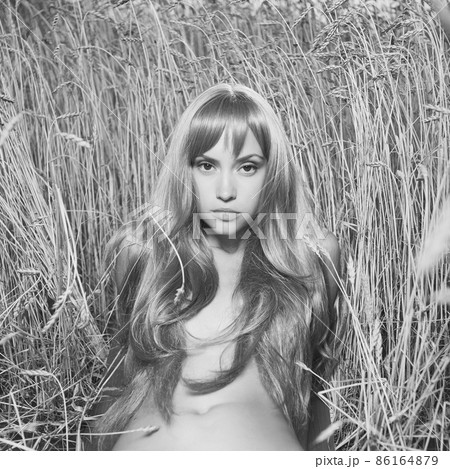 Nude beautiful woman is showing her naked body outside. Nude beautiful woman is showing her naked body outside. 86164879
