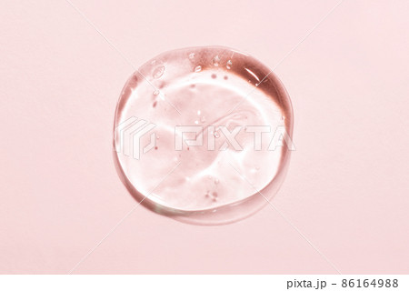 Transparent hyaluronic acid gel drop on a pink background. Transparent hyaluronic acid gel drop on a pink background. 86164988
