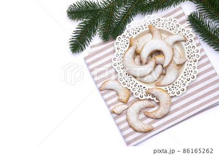 Traditional German or Austrian Vanillekipferl vanilla kipferl cookies on a plate isolated on white background Traditional German or Austrian Vanillekipferl vanilla kipferl cookies on a plate isolated on white background 86165262