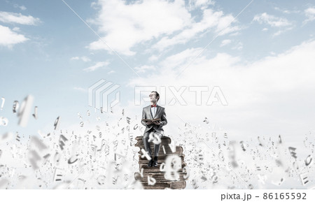 Young businessman or student studying the science and symbols fly around 86165592
