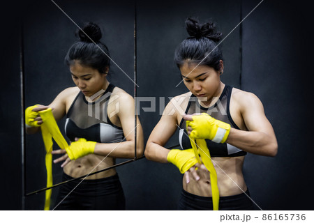 Asian boxer woman wearing bandage strap on wrist Asian boxer woman wearing bandage strap on wrist 86165736
