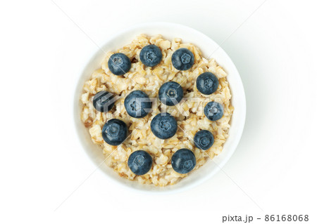 Bowl of oatmeal with tasty ingredients isolated on white background Bowl of oatmeal with tasty ingredients isolated on white background 86168068