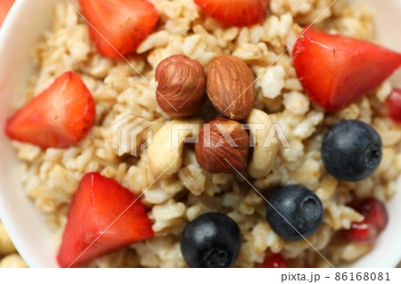 Fresh cooked oatmeal with fruits, close up 86168081