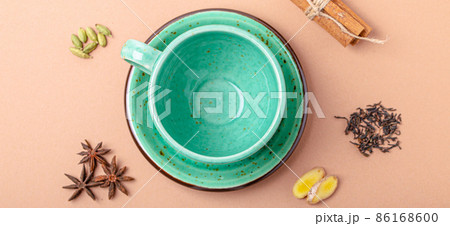 Empty green teacup and spices ingredients for making healthy Indian tea drink masala chai Empty green teacup and spices ingredients for making healthy Indian tea drink masala chai 86168600