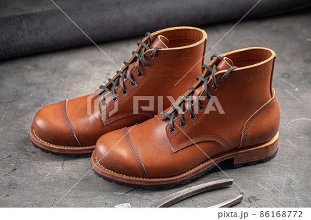 Handcrafted brown leather shoes with cobbler tools Handcrafted brown leather shoes with cobbler tools 86168772