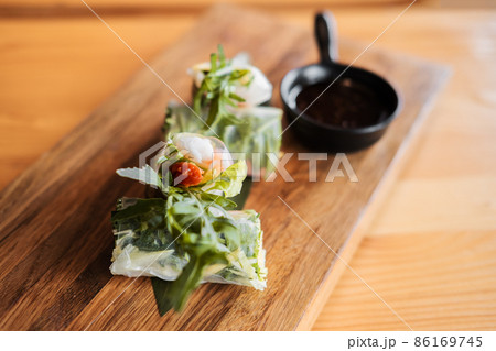 Spring rolls with shrimp, wooden chopsticks and soy sauce. Asian cuisine. Spring rolls with shrimp, wooden chopsticks and soy sauce. Asian cuisine. 86169745