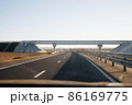 View of empty open road from car window. 86169775
