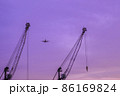 Airplane flying in the violet sky. Travel and flight concept 86169824