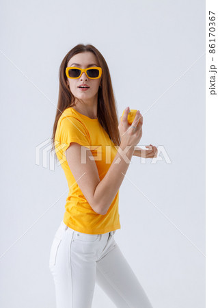 Charming woman in stylish sunglasses holding perfume Charming woman in stylish sunglasses holding perfume 86170367