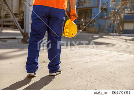Frustrated foreman with hard hat in factory Frustrated foreman with hard hat in factory 86170391
