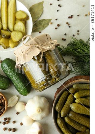 Fresh pickles and ingredients on white textured table Fresh pickles and ingredients on white textured table 86171411