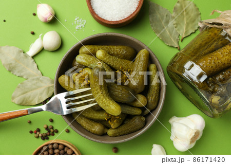 Fresh pickles and ingredients for cooking on green background 86171420