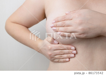 Caucasian woman chest looking for signs of male breast cancer. Breast examination by herself 86173542