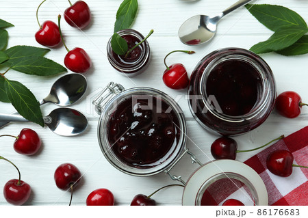Cherry jam and ingredients on white wooden table Cherry jam and ingredients on white wooden table 86176683