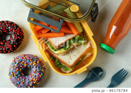 Concept of tasty eating with lunch box on white textured table 86176784