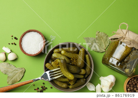 Fresh pickles and ingredients for cooking on green background 86176919