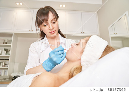 Permanent makeup. Beauty spa procedure. young woman. Face tattoo 86177366