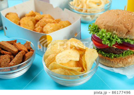 Concept of fast food on blue background Concept of fast food on blue background 86177496