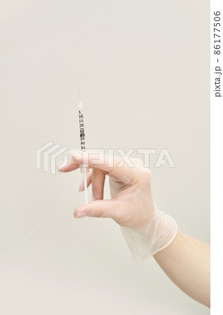 Person in transparent glove hold vaccine syringe. Injection pharmacy concept Person in transparent glove hold vaccine syringe. Injection pharmacy concept 86177506