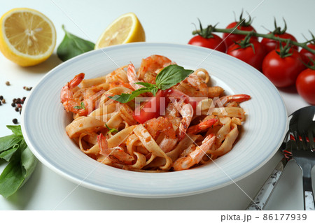 Plate of shrimp pasta and ingredients on white background Plate of shrimp pasta and ingredients on white background 86177939