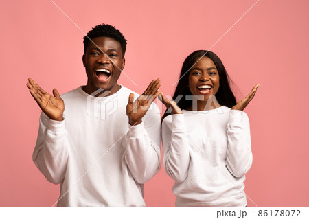 Emotional black couple gesturing on pink background Emotional black couple gesturing on pink background 86178072