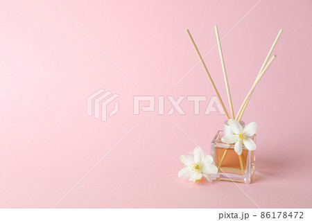 Aroma scent diffuser and flowers on pink background Aroma scent diffuser and flowers on pink background 86178472
