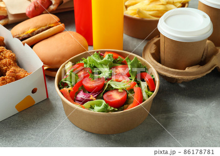 Different fast food on gray textured table 86178781