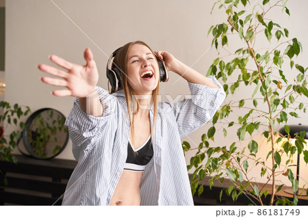 Young woman sing at home. House lyrics dance. Funny song. Independent portrait Young woman sing at home. House lyrics dance. Funny song. Independent portrait 86181749