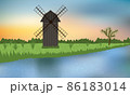 Wooden windmill on the green camp near the blue river. 86183014