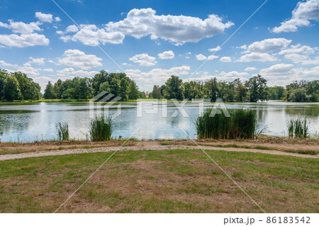 Lednice-Valtice complex, castle pond , park with trees and castle Lednice 86183542