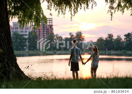 Happy siblings standing together looking at building under construction. Young children brother and sister relaxing outdoors dreaming about their future home. Family love and relationship concept Happy siblings standing together looking at building under construction. Young children brother and sister relaxing outdoors dreaming about their future home. Family love and relationship concept 86183654