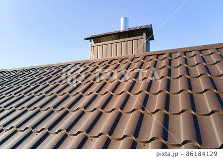 Closeup of house roof top covered with metallic shingles Closeup of house roof top covered with metallic shingles 86184129
