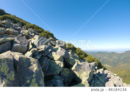 Rocky mountain hillside with big stone boulders on sunny day 86184136