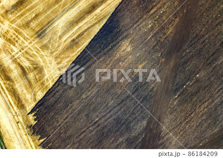 Aerial view of plowed agricultural field prepared for planting crops in spring 86184209