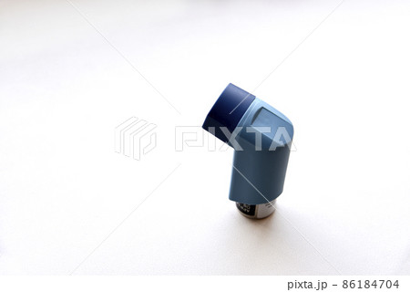 Asthma inhaler spray on a white background 86184704