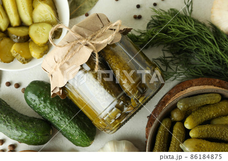 Fresh pickles and ingredients on white textured table Fresh pickles and ingredients on white textured table 86184875