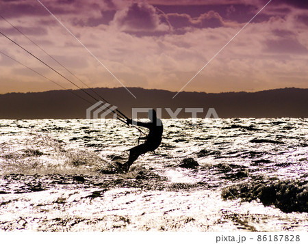 Kite surfer riding waves. Kiteboarding sport. Kite surfer riding waves. Kiteboarding sport. 86187828
