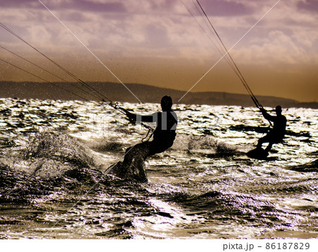 Kite surfer riding waves. Kiteboarding sport. Kite surfer riding waves. Kiteboarding sport. 86187829
