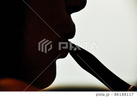 Retro portrait of a young woman smoking hookah in the cafe or bar close up 86188117