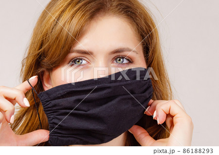 Woman using protective face mask. Woman using protective face mask. 86188293