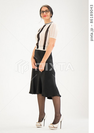 Studio photo of middle aged woman starting getting grey-haired wearing black and white clothes on white background, middle age sexy lady, happy life concept Studio photo of middle aged woman starting getting grey-haired wearing black and white clothes on white background, middle age sexy lady, happy life concept 86189043