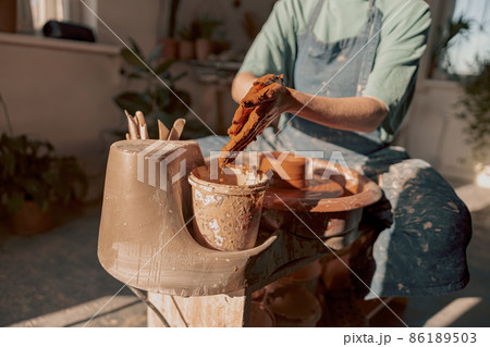 Woman master ceramist working at her studio Woman master ceramist working at her studio 86189503