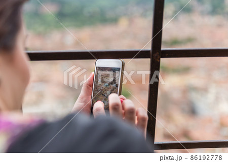 Taking picture of Bologna with cellphone from top of tower Taking picture of Bologna with cellphone from top of tower 86192778