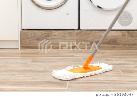 Cleaning floor in laundry room in modern house 86193047